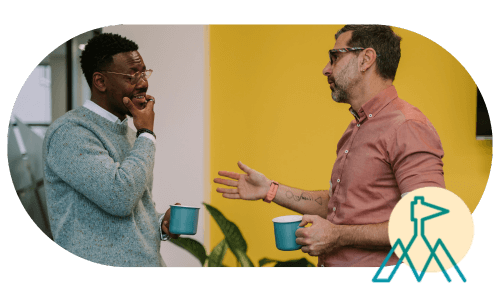 Two leaders engaged in thoughtful conversation, uplifting and supporting each other. Boosting employee mental health.